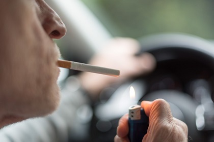 車内でたばこを吸う男性